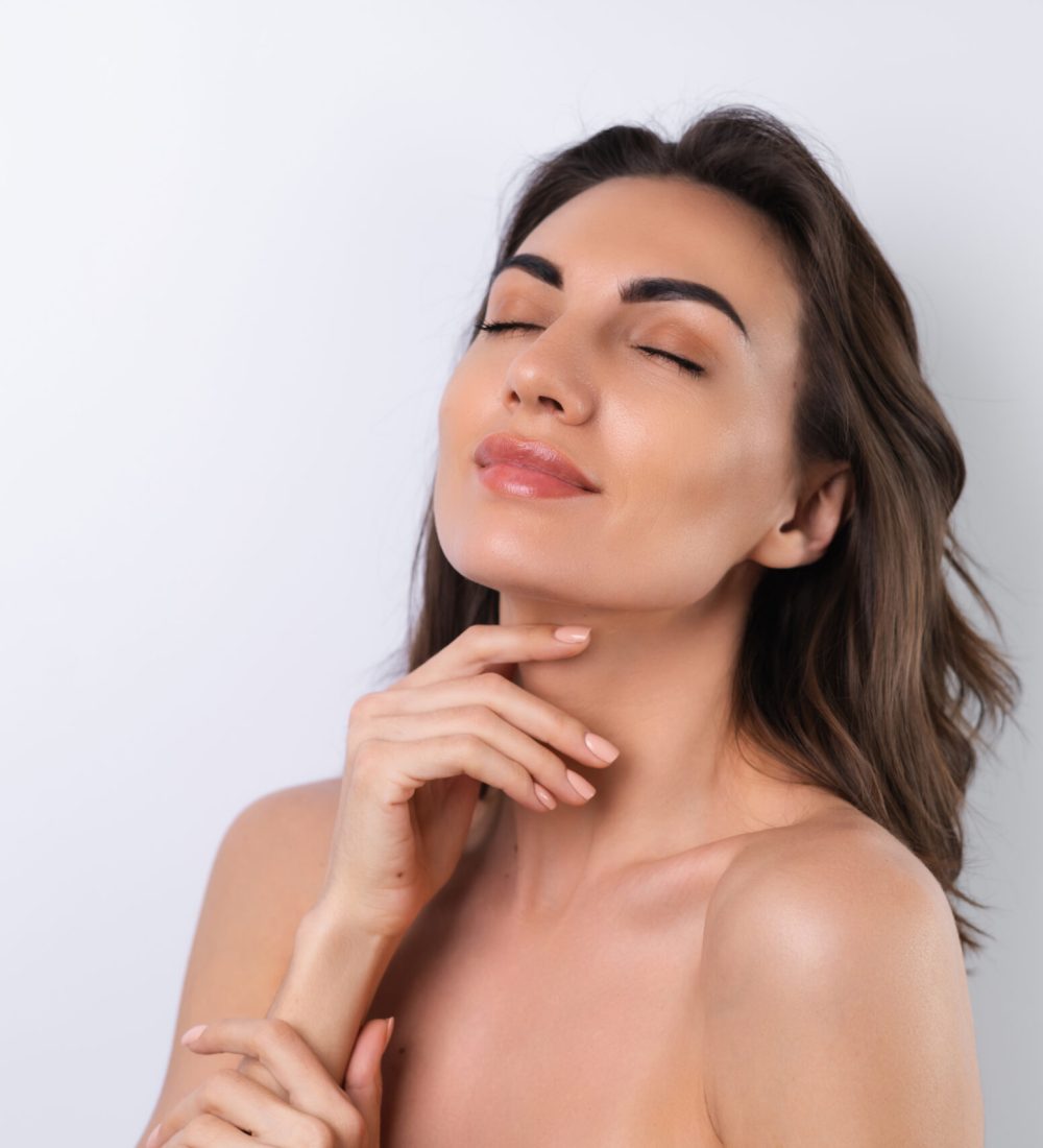 Close-up beauty portrait of a topless woman with perfect skin and natural make-up